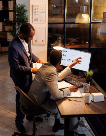 young-businesswoman-her-colleagues-brainstorming-while-using-desktop-pc-office-scaled.avif